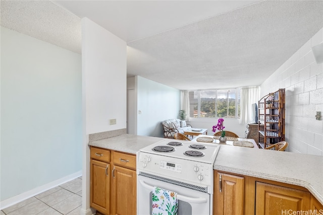 kitchen featuring light tile patterned floors, a textured ceiling, and white electric stove