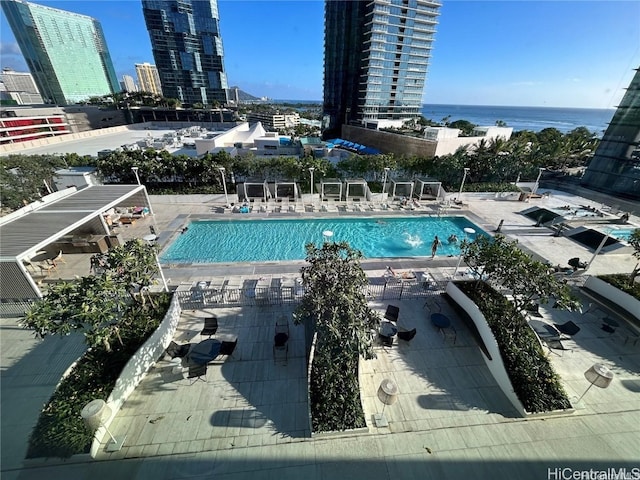 view of swimming pool with a water view