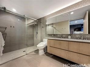 bathroom with tile patterned flooring, an enclosed shower, toilet, decorative backsplash, and vanity