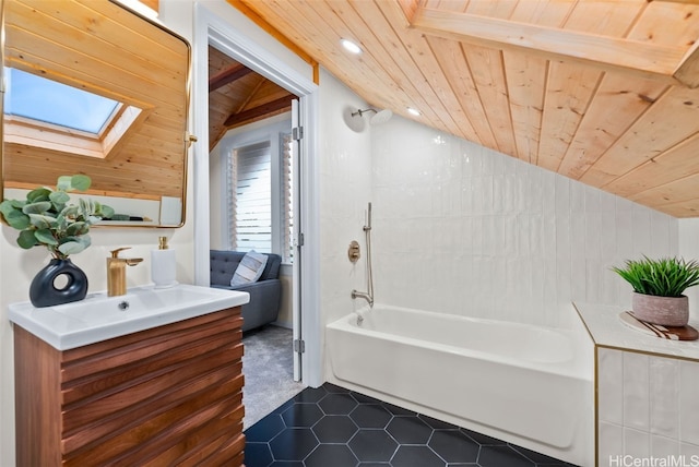 bathroom with vaulted ceiling with skylight, vanity, shower / tub combination, wooden ceiling, and tile patterned flooring