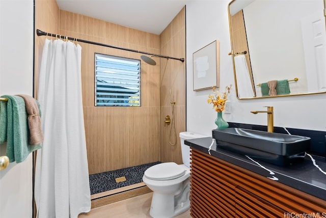 bathroom with a shower with curtain, hardwood / wood-style floors, vanity, and toilet