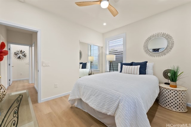 bedroom with light hardwood / wood-style floors and ceiling fan