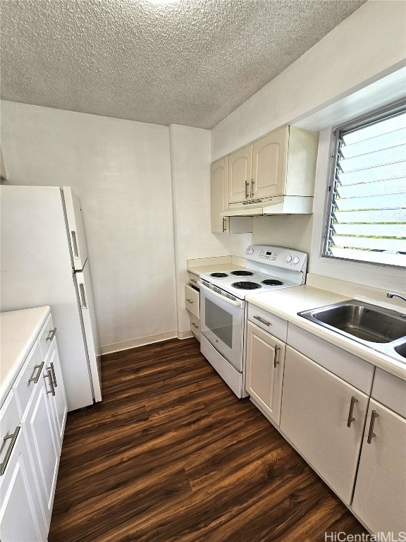 kitchen with white cabinetry, sink, white appliances, and dark wood-type flooring