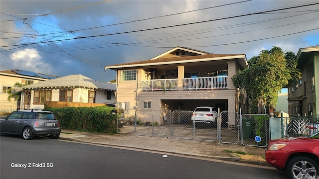 911 Winant St, Honolulu, HI 96817 - view of front of property with a gate, a balcony, a garage, driveway, and stucco siding