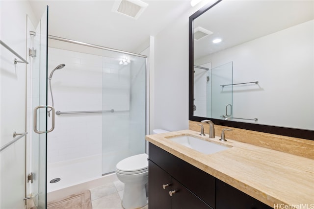 bathroom with tile patterned flooring, vanity, toilet, and walk in shower