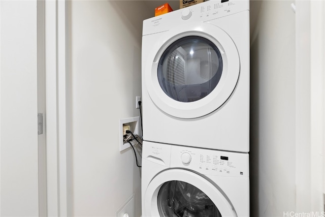 laundry area featuring stacked washer / dryer