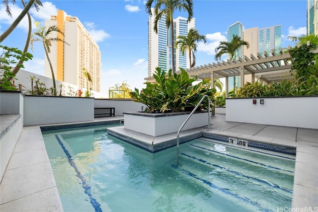 view of swimming pool featuring a patio area and a pergola