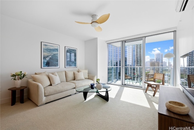 living room featuring a wall mounted air conditioner, ceiling fan, expansive windows, and carpet floors