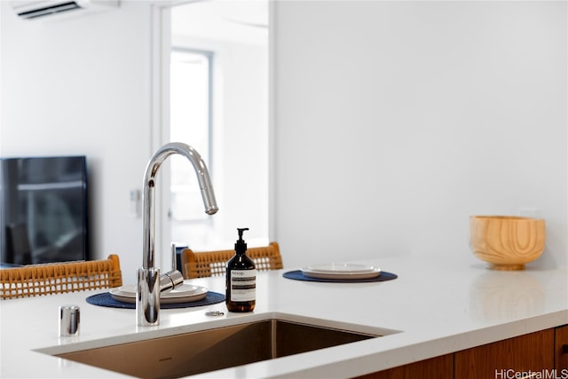 room details featuring a wall mounted air conditioner and sink