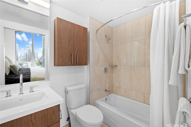 full bathroom featuring vanity, shower / tub combo, and toilet