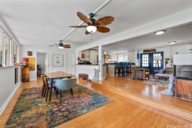 dining area with light hardwood / wood-style flooring and french doors