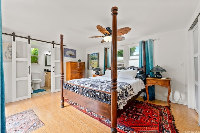 763 Kaipii St, Kailua, HI 96734 - bedroom featuring light wood finished floors, a barn door, ensuite bathroom, and ceiling fan