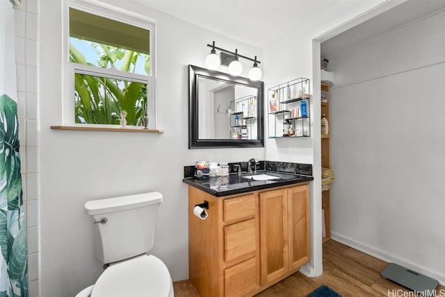 bathroom with hardwood / wood-style flooring, vanity, toilet, and a shower with curtain