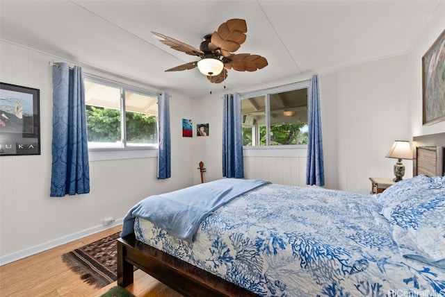 bedroom with wood-type flooring and ceiling fan