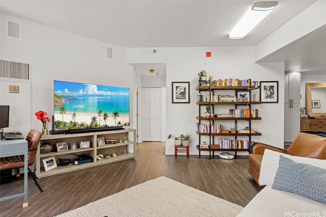 living room featuring dark hardwood / wood-style flooring and a textured ceiling