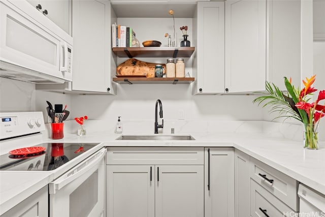 kitchen featuring white cabinets, white appliances, and sink