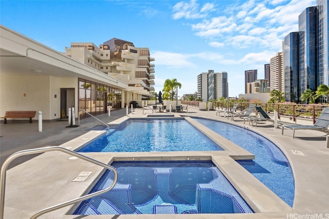 view of swimming pool with a community hot tub and a patio