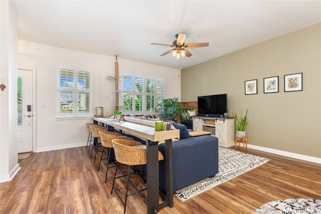 living room featuring dark hardwood / wood-style floors and ceiling fan