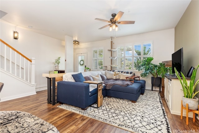 living room featuring dark hardwood / wood-style floors and ceiling fan