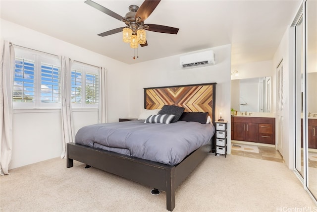 carpeted bedroom with ensuite bath, ceiling fan, sink, and a wall mounted AC