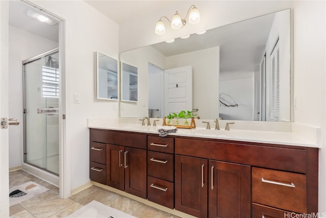 bathroom featuring vanity and an enclosed shower