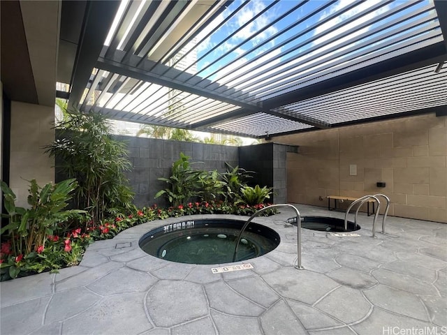 view of pool with an in ground hot tub and a patio