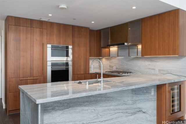 kitchen featuring backsplash, sink, light stone countertops, appliances with stainless steel finishes, and dark hardwood / wood-style flooring