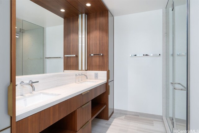 bathroom with decorative backsplash, hardwood / wood-style floors, vanity, and an enclosed shower