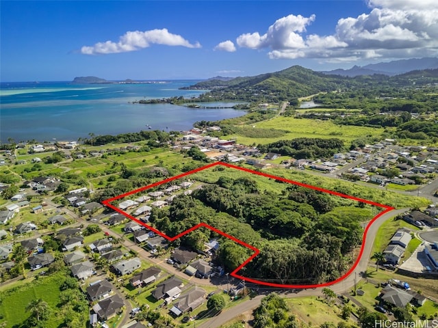 birds eye view of property with a water and mountain view