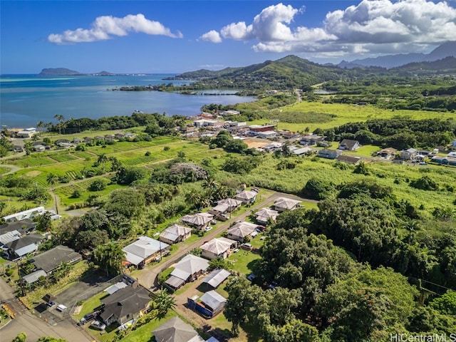 drone / aerial view featuring a water and mountain view