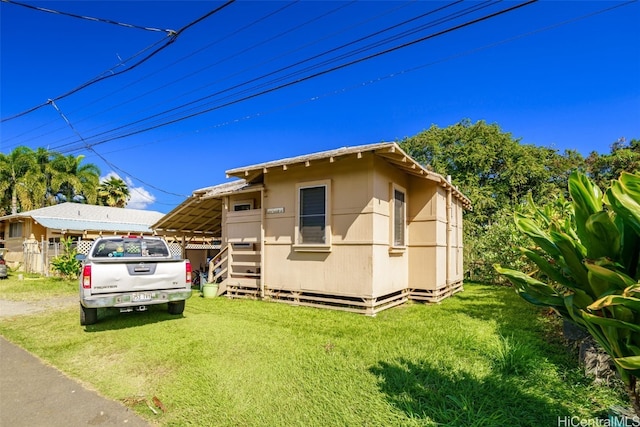 rear view of property featuring a lawn