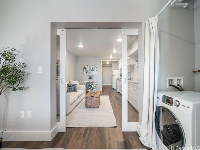 laundry area with washer / dryer and dark hardwood / wood-style floors