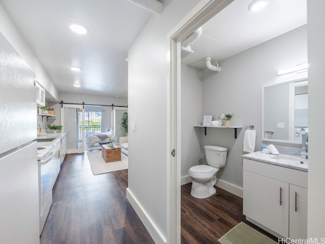 bathroom featuring hardwood / wood-style floors, vanity, and toilet