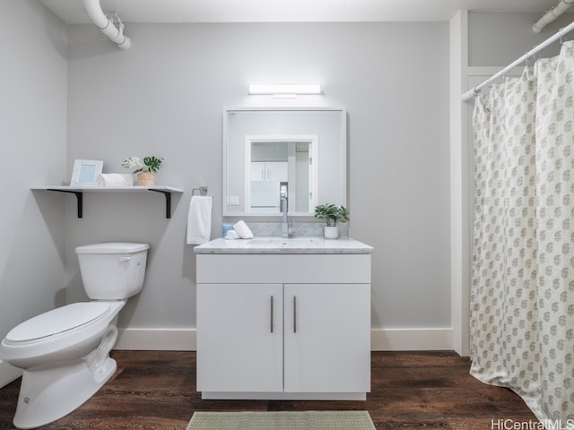 bathroom with a shower with shower curtain, wood-type flooring, vanity, and toilet