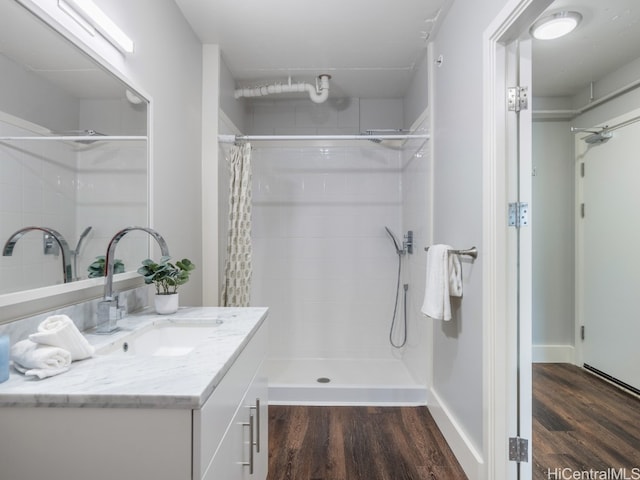 bathroom with hardwood / wood-style floors, vanity, and a shower with shower curtain