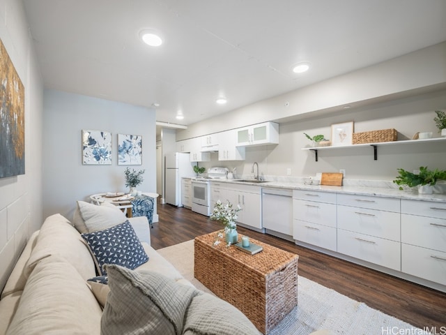 living room with dark hardwood / wood-style floors and sink