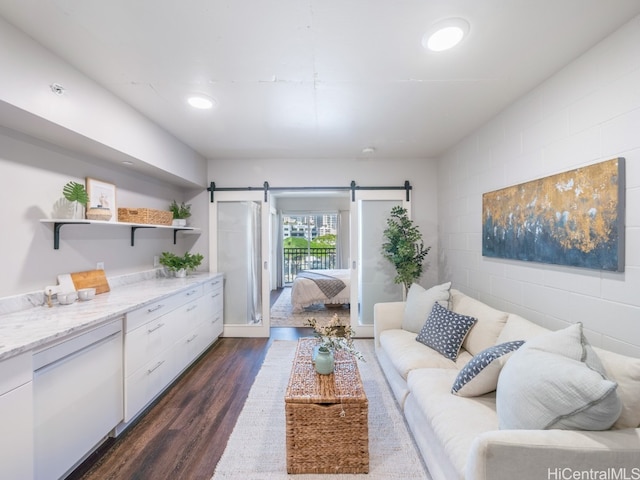 living room featuring dark hardwood / wood-style floors and a barn door