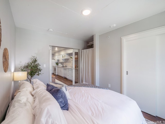 bedroom with dark hardwood / wood-style flooring and sink