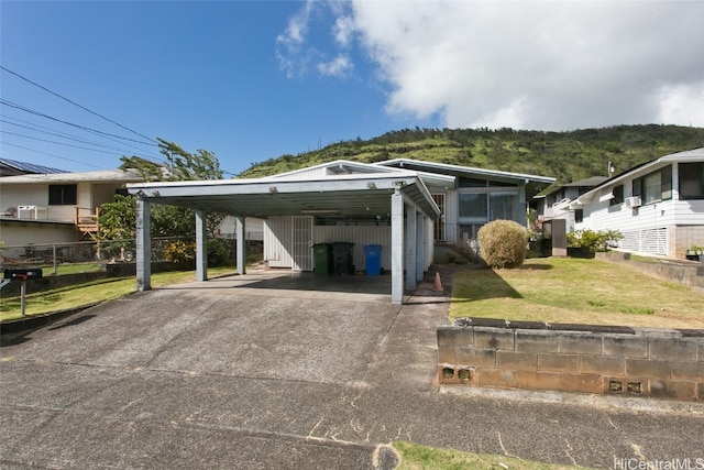 view of car parking featuring a carport and a lawn