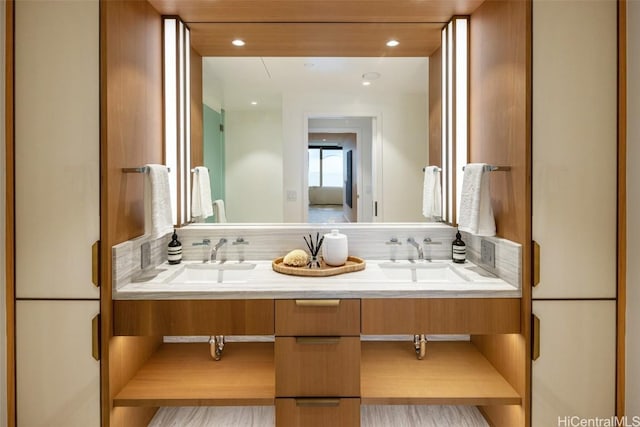 bathroom with decorative backsplash and vanity