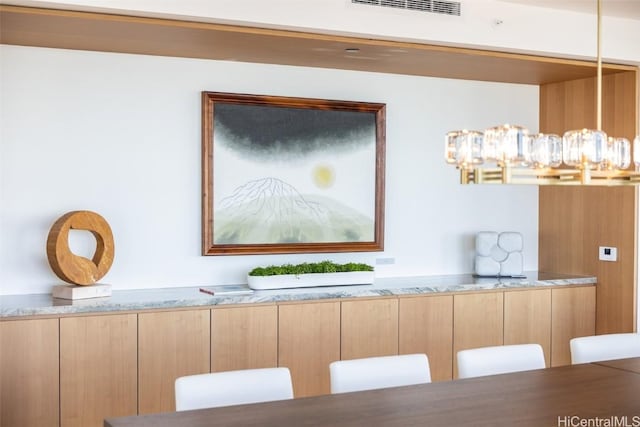 unfurnished dining area featuring an inviting chandelier