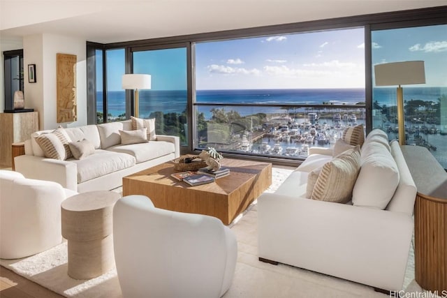 living room featuring light hardwood / wood-style floors, a water view, and a wealth of natural light