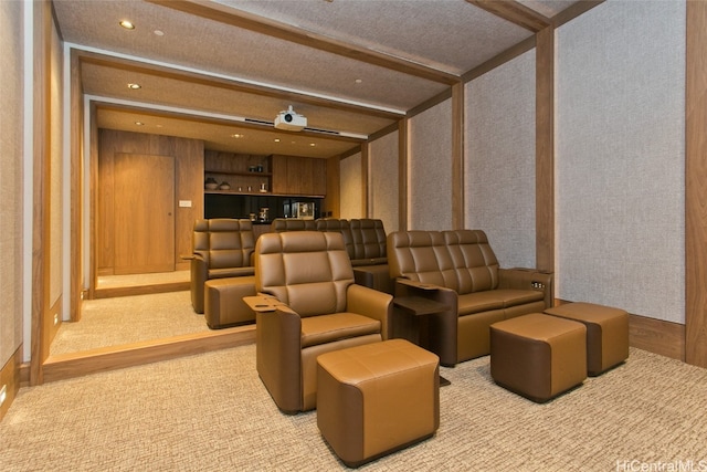 carpeted cinema featuring beamed ceiling, a textured ceiling, and bar area