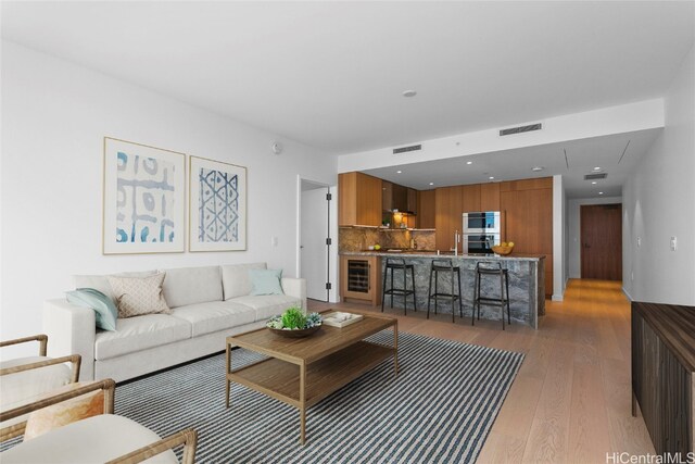 living room featuring beverage cooler and dark hardwood / wood-style floors