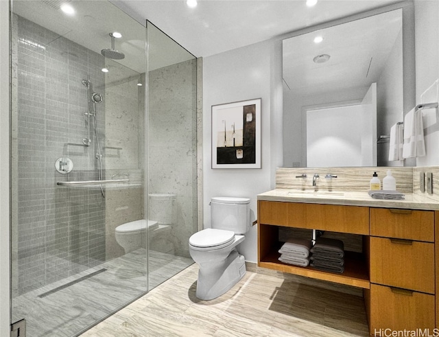 bathroom with vanity, hardwood / wood-style flooring, toilet, and walk in shower