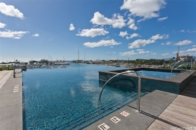 view of pool featuring a water view