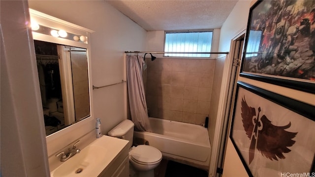 full bathroom with vanity, shower / bath combo, a textured ceiling, and toilet