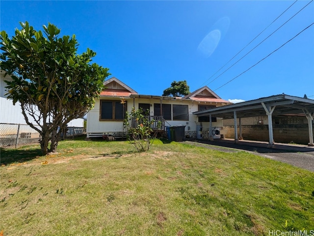 view of front facade featuring a front lawn and a carport