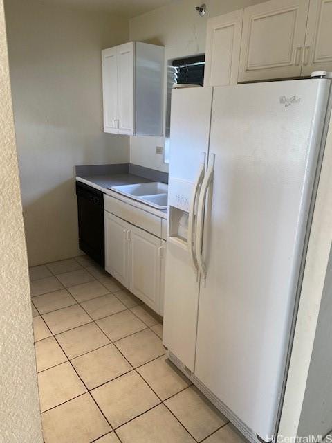 3054 Ala Poha Pl Unit 1906, Honolulu, HI 96818 - kitchen featuring white refrigerator with ice dispenser, black dishwasher, white cabinetry, and light tile patterned floors