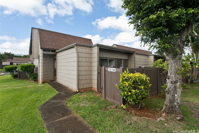 view of side of property with a yard